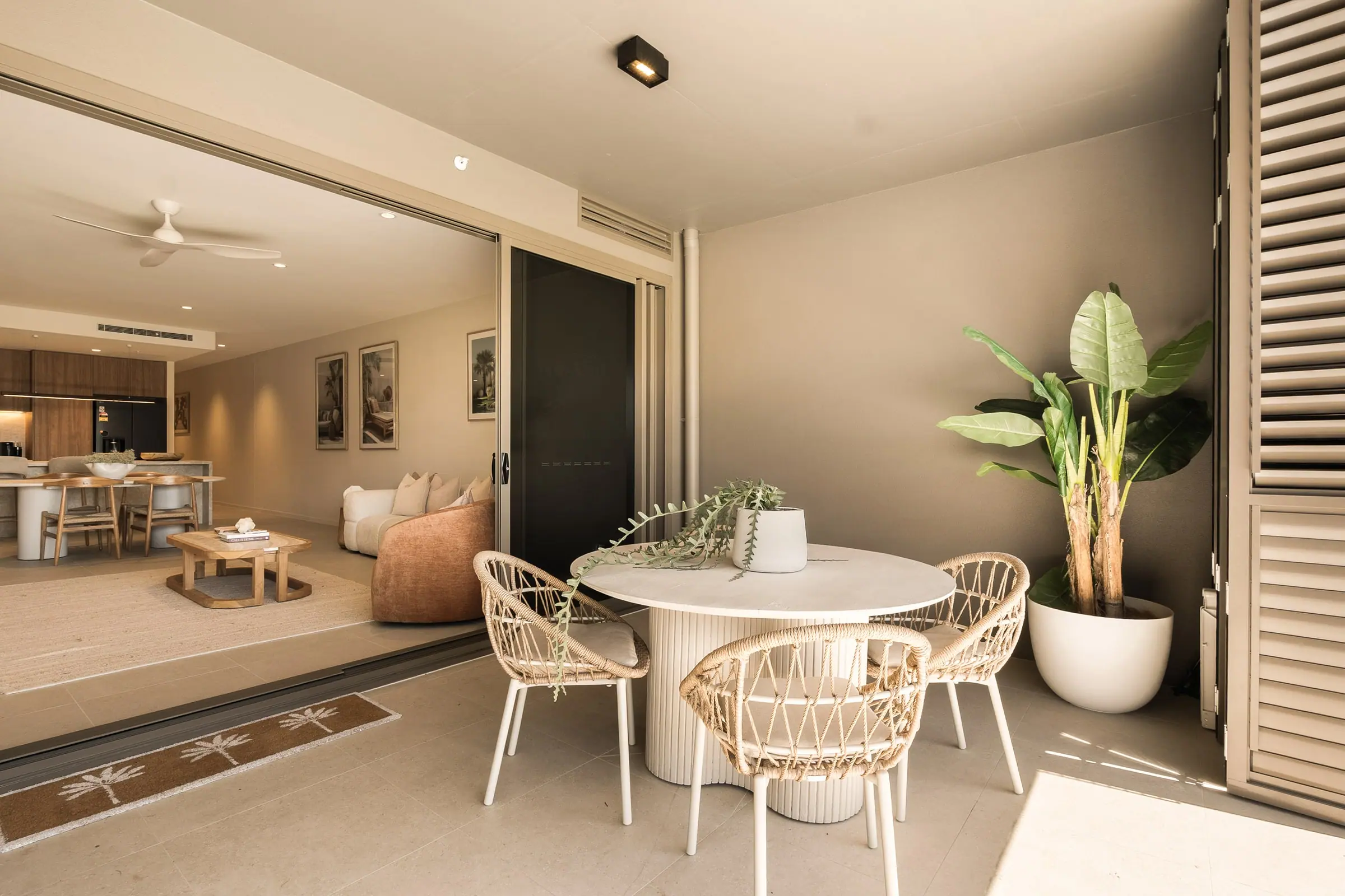 Balcony dining, with the living room opening up behind it