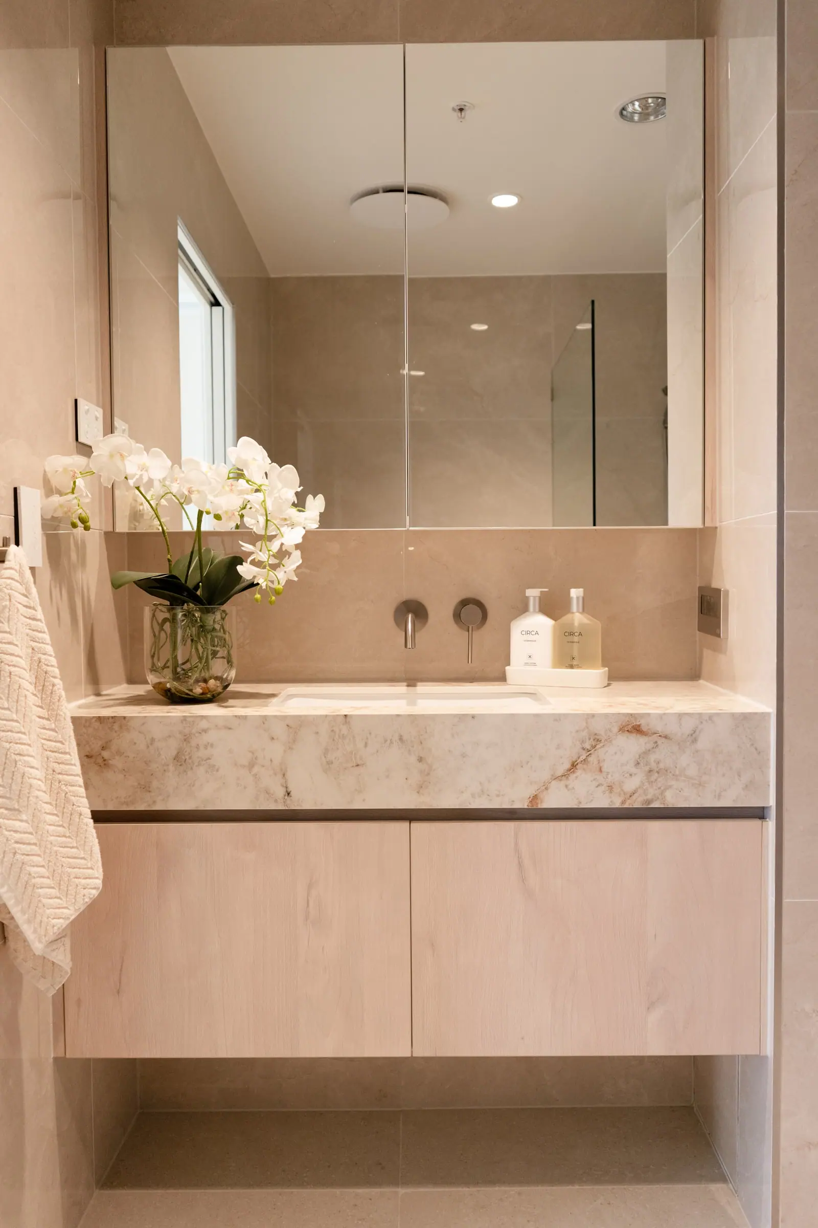 Ensuite with a stone vanity and walk-in rain shower