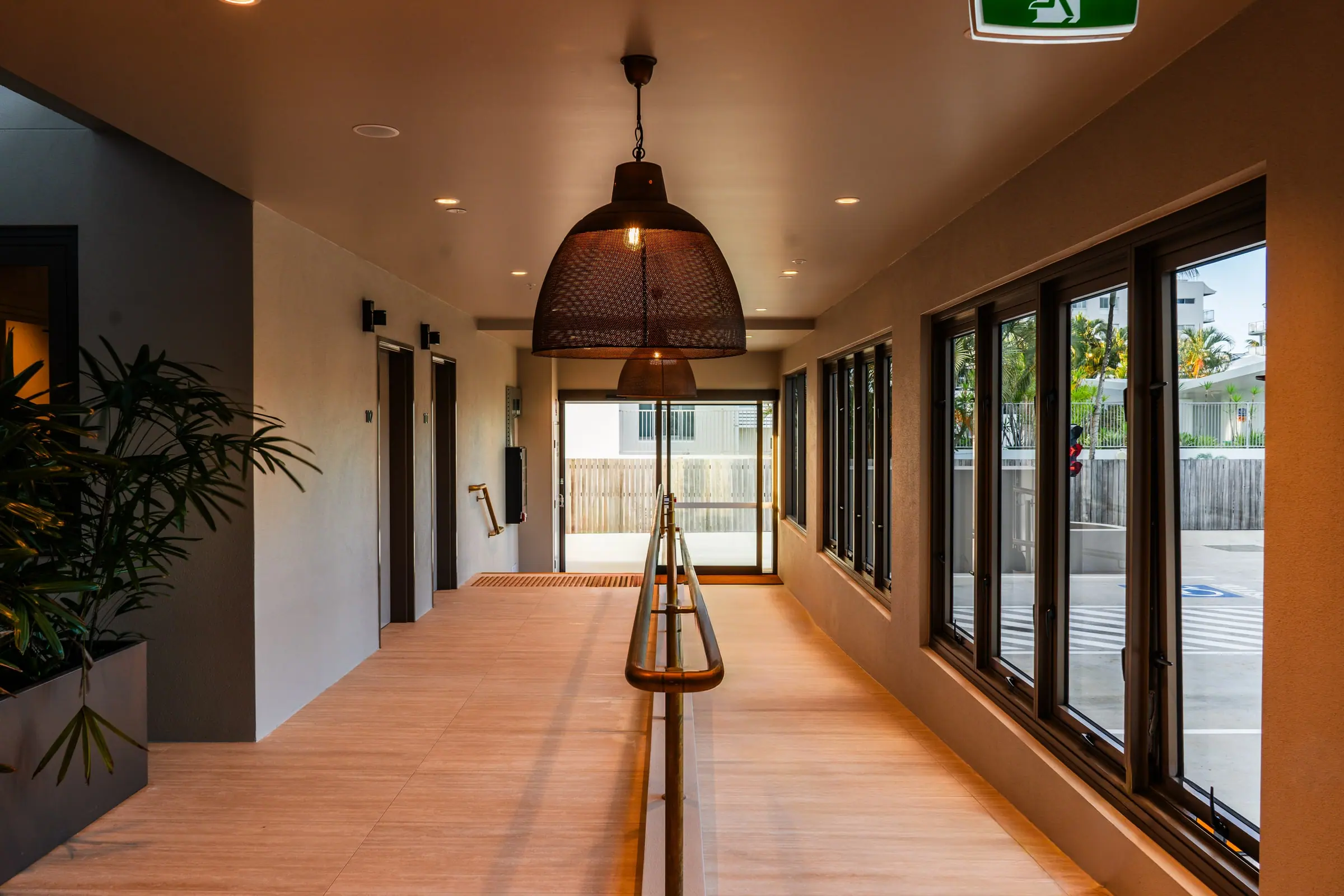 The Mira Living lobby, with its timber ceiling and woven pendant light